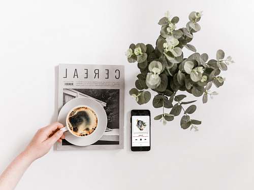 electronics flat lay photography of smartphone, newspaper, and teacup mobile phone